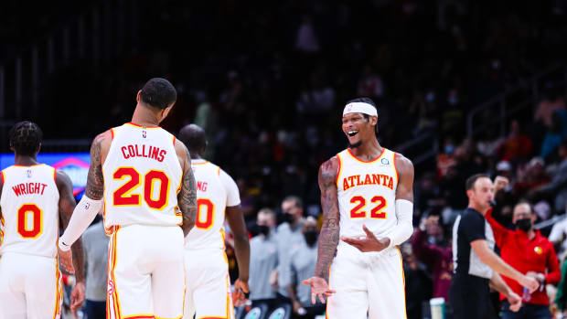 Atlanta Hawks forward John Collins (20) celebrates with forward Cam Reddish (22) during the third quarter against the Detroit Pistons at State Farm Arena.